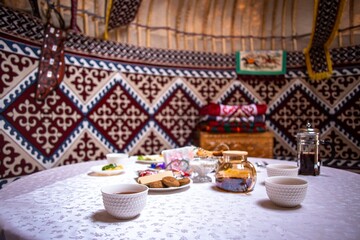 Cozy Yurt Interior with Traditional Meal Table Setup and Colorful Decor