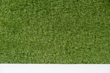Product presentation background made with green artificial grass and white tabletop.