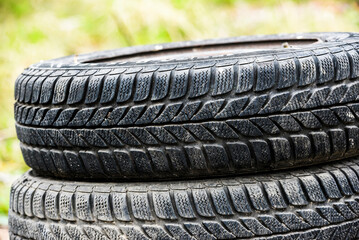 Old worn out tires lying on top of each other.