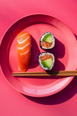 sushi with salmon on a pink plate