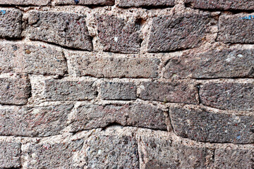 Abstract background from warped antique brick wall.