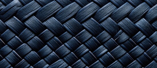 A detailed look at a navy blue woven textile showcasing a wicker pattern, revealing the intricate structure of vintage fabric.
