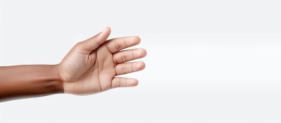 A human hand extends upwards towards the sky, fingers outstretched. The hand is holding a white paper against a transparent background.