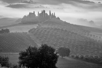 Fairy-tale magical misty morning in the mountains and valley near San Quirico d'Orcia, Tuscany,...