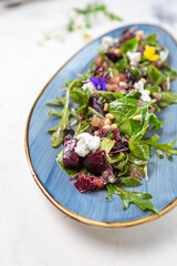 Organic baby greens salad with beets, goat cheese, pistachios, citrus dressing