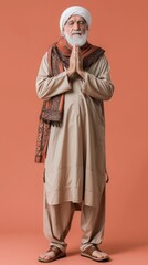 Muslim old man, studio portrait and islamic culture standing isolated on studio background with arabic clothes.