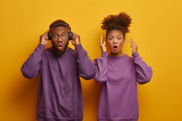 Young curious nosy couple two friend family man woman of African American ethnicity wear purple casual clothes together try to hear you overhear listening intently isolated on plain yellow background - obrazy, fototapety, plakaty