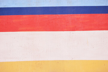 Abstract background of red blue, yellow and white stripes.
