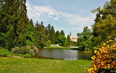 Castle park with lake and forest, castle in the background. Czech Republic, Průhonice