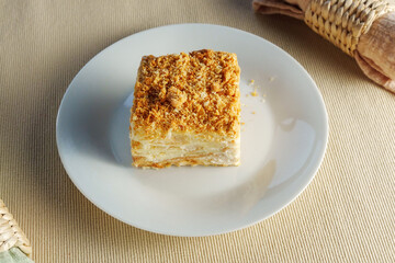 Delectable Delight: A Tempting Slice of Cake Adorning a Pure White Porcelain Plate
