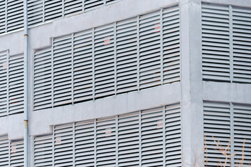 Building adorned in countless windows creates a kaleidoscopic effect. Building geometry