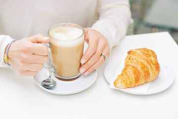 Close up image of freshly baked croissant and cafe latte - 745993705