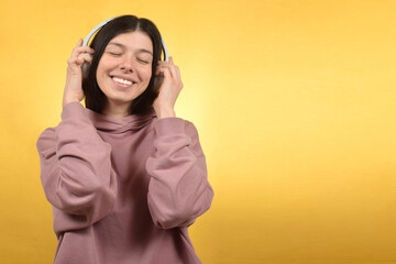 Young beautiful woman listening to music 