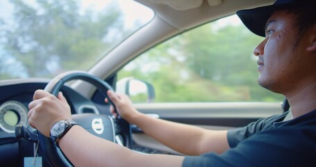Asian man Hands holding on the Steering Wheel while driving a car, Driving Safety and Automotive Control, Road Trip Adventure