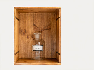 borosilicate glass chemical bottle isolated in a wooden crate box on a white background
