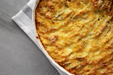 Homemade Hasselback Potato Gratin in a Dish, top view. Copy space.