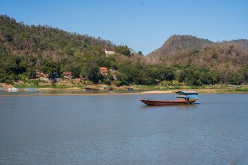 Obraz premium Laotian wooden boats on the Mekong River in Luang Prabang in Laos Southeast Asia