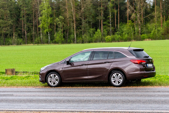 Brown Opel Astra K (B16) Sports Tourer station wagon parked on the side of the road