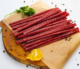 Products made from fish strips are used as snacks and appetizers placed on a white background.