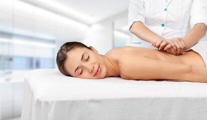 Obraz na płótnie Canvas Young woman has back massage in spa salon