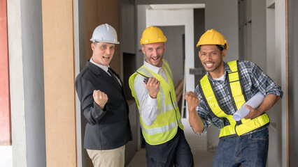 Construction team celebrating a successful project on site. Teamwork and construction progress concept.