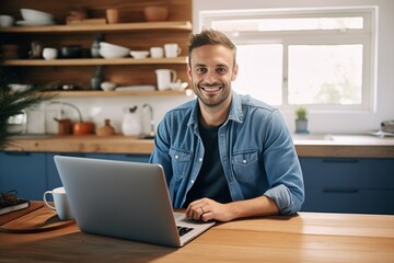 Fototapeta na wymiar Man at home working on a laptop computer smiling