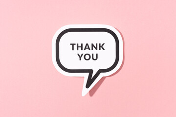 Thank you text on speech bubble isolated on pink background