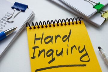 Yellow notepad with words hard inquiry and notepads.