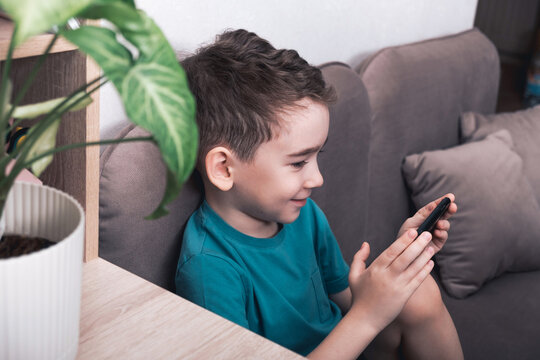 Smiling child engaging with smartphone technology