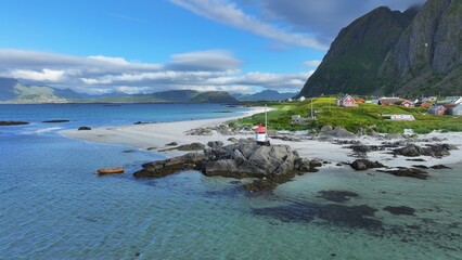Fototapeta na wymiar Canoe and lighthouse on the Lofoten Islands, Norway