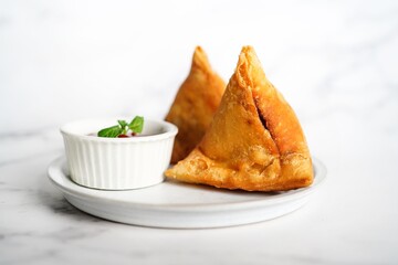 Samosa served with tomato sauce- Indian vegetarian appetizer, selective focus