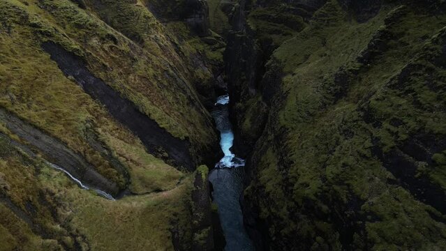 Aerial Breathtaking view of River Waterfall between mountains in Fjaorargljufur Canyon, Iceland