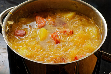 Cabbage soup in cooking pot