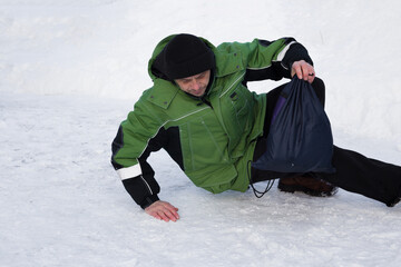 Fototapeta na wymiar A European man slipped on the ice and fell.