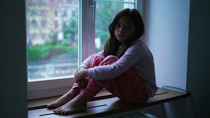 Depressed Little Girl by Window, Anxiety and Worry in Childhood. Child feeling lonely at home...