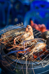 Grilled shrimp, a seafood delight on ice, with a mix of fresh crustaceans showcasing red and white hues, capturing the essence of a delicious seafood meal