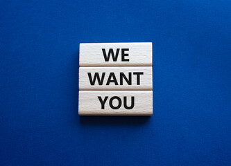 We want you symbol. Concept words We want you on wooden blocks. Beautiful deep blue background. Business and We want you concept. Copy space.