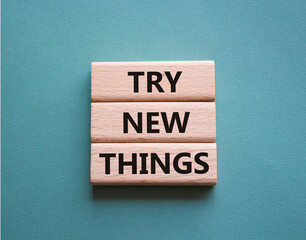 Try new Things symbol. Concept words Try new Things on wooden blocks. Beautiful grey green background. Business and Try new Things concept. Copy space.
