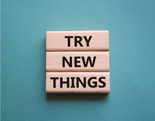 Try new Things symbol. Concept words Try new Things on wooden blocks. Beautiful grey green...