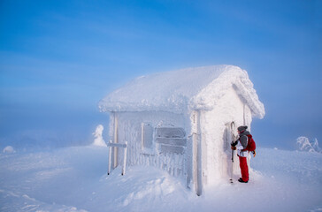 Woman snowshoeing in snowy mountain in Lapland Finland