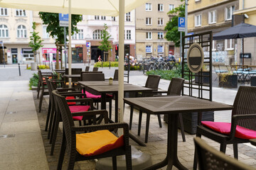 Fototapeta na wymiar Outdoor Dining Area With Tables, Chairs, and Umbrellas