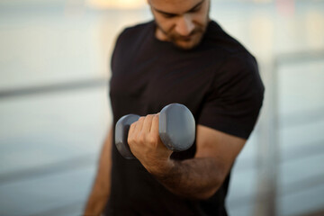 Cropped shot of fitness guy having workout session with dumbbells