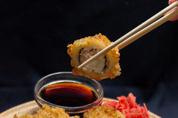 Gingerbread rolls soaked in soy sauce on a dark background