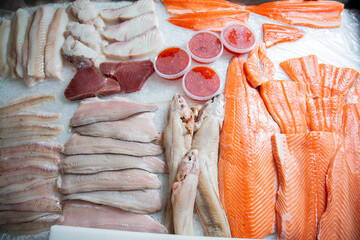 Fresh fish and seafood counter on market. Salmon, trout and white fish fillet, tuna steak and red...