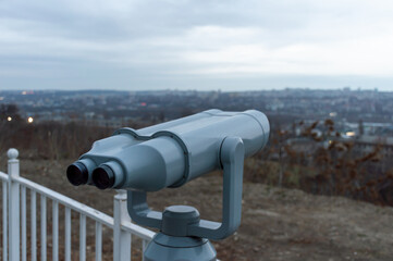 Grey binoculars at the observation deck on a cloudy day