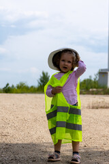 Girl in a green vest and with a helmet on her head
