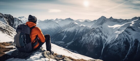 Solitude and Contemplation: Man Embracing Tranquility on Snow-Covered Mountains Summit - obrazy, fototapety, plakaty