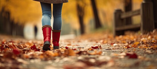 Stylish Woman Strolling Through Autumn Park in Vibrant Red Boots