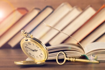 Old vintage retro watch and key on books