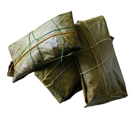 Three tamales wrapped in banana leaf on white background.
